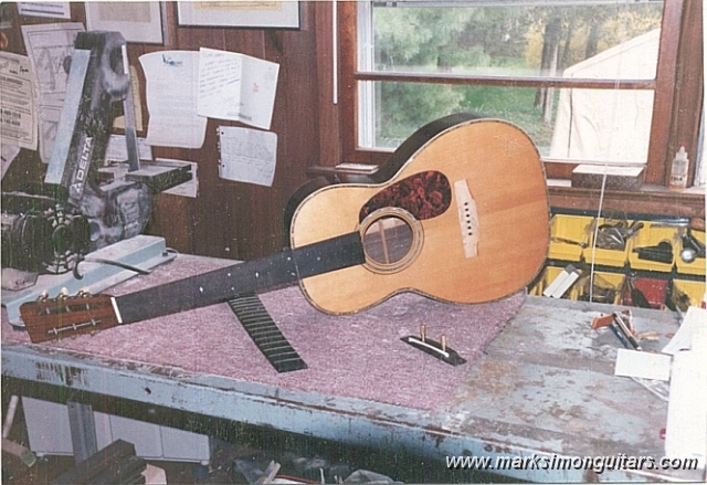 0040brbig.jpg - Martin 00-40 with corrected neck angle. The neck has been glued back at this point and the new fingerboard is installed. The diamonds and squares inlays have been glued in and sanded flush with the fingerboard. Note that one fret has been installed at the 12th fret to check for correct bridge placement. The bridge has 2 tapered aligning pins which prevent it from shifting when being glued.